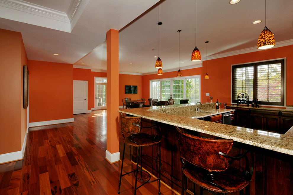 Family room - large traditional open concept dark wood floor family room idea in Richmond with a bar, orange walls, no fireplace and a wall-mounted tv