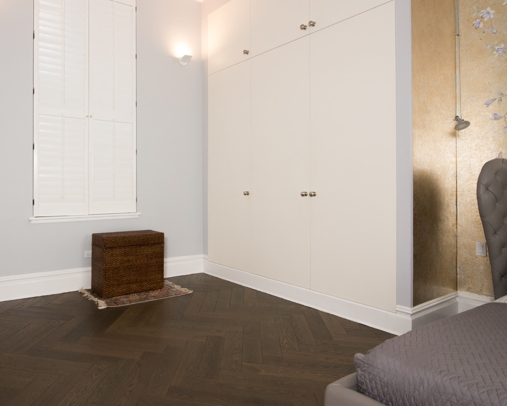 Design ideas for an asian storage and wardrobe in New York with white cabinets and dark hardwood floors.