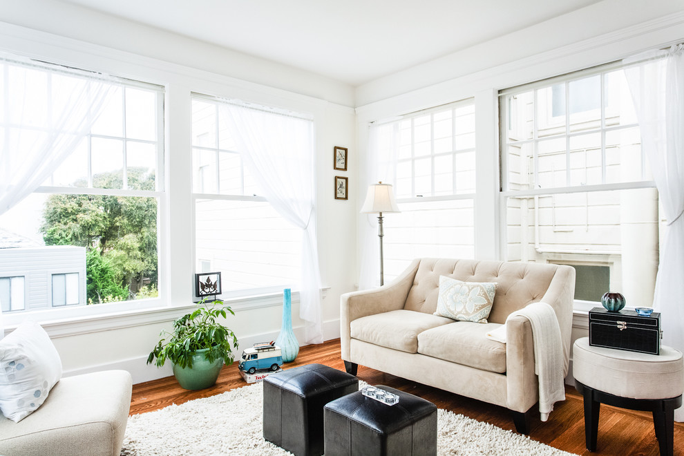 Photo of a contemporary living room in San Francisco with white walls and dark hardwood floors.