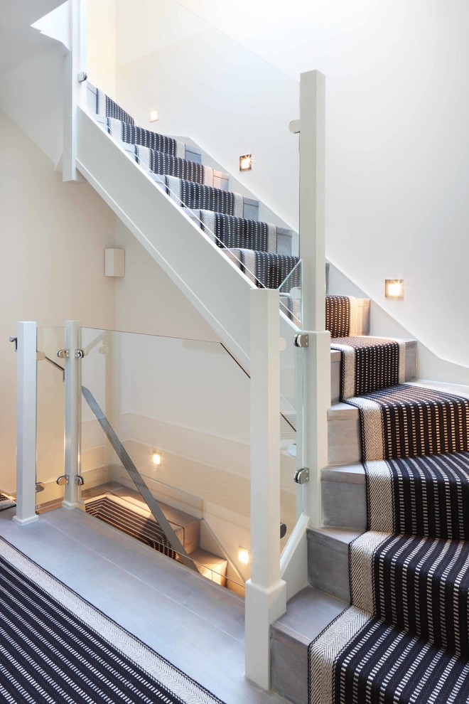 Design ideas for a mid-sized contemporary wood l-shaped staircase in London with wood risers.