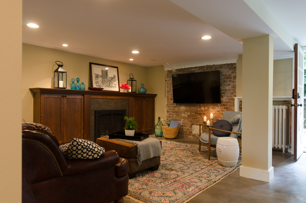 Photo of a mid-sized traditional walk-out basement in Seattle with beige walls, concrete floors, a tile fireplace surround, grey floor, a standard fireplace and brick walls.