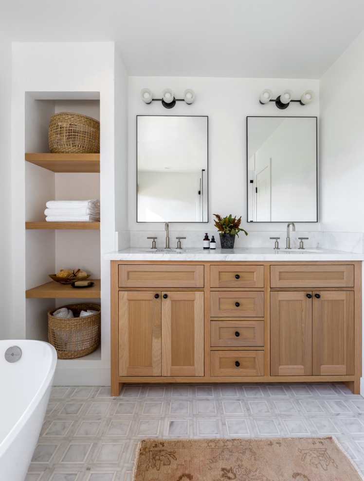 Classic bathroom in San Diego with a freestanding bath, an alcove shower, a one-piece toilet, white walls, marble flooring, a submerged sink, marble worktops, a hinged door, a wall niche, double sinks, a built in vanity unit and shaker cabinets.