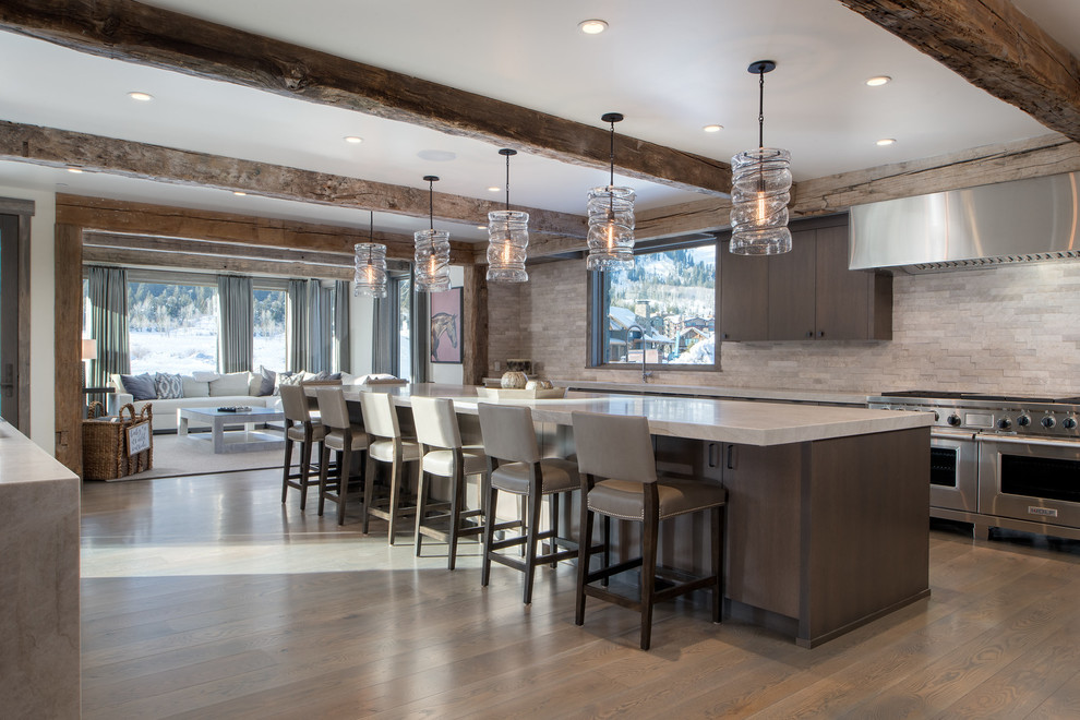 Inspiration for a rustic medium tone wood floor and brown floor open concept kitchen remodel with flat-panel cabinets, dark wood cabinets, beige backsplash, stainless steel appliances and an island