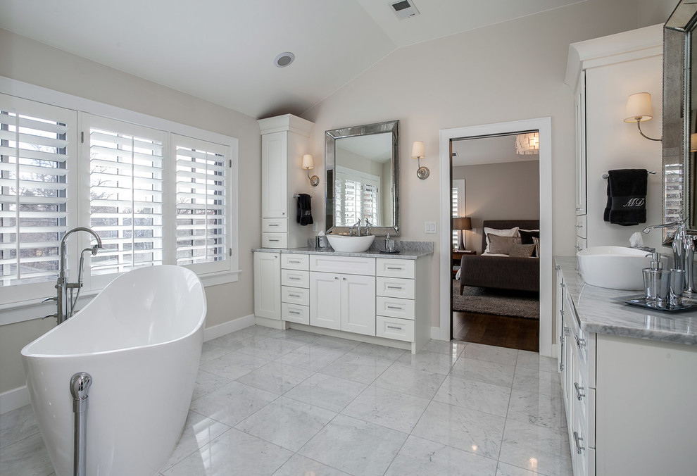 Inspiration for a mid-sized transitional master bathroom in Denver with shaker cabinets, white cabinets, a freestanding tub, white tile, white walls, ceramic floors, granite benchtops, a vessel sink, white floor and grey benchtops.