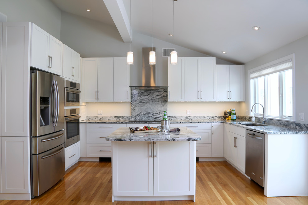 Design ideas for a mid-sized transitional u-shaped eat-in kitchen in Providence with an undermount sink, shaker cabinets, white cabinets, granite benchtops, white splashback, stone slab splashback, stainless steel appliances, medium hardwood floors and with island.