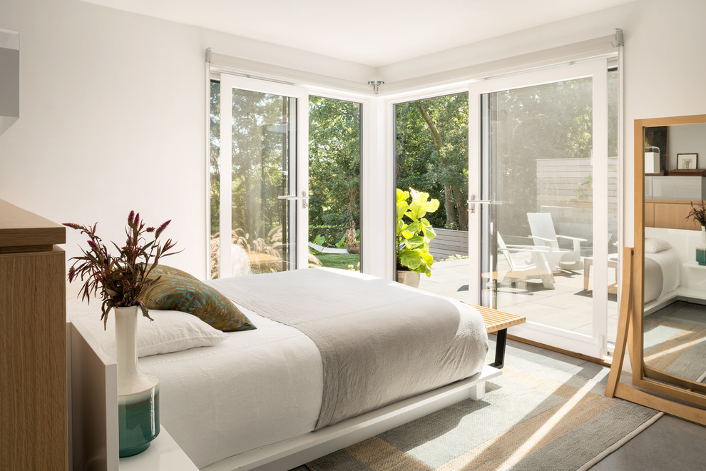 Bedroom - contemporary concrete floor and gray floor bedroom idea in Boston with white walls