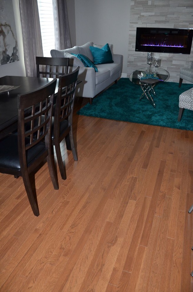 Inspiration for a large transitional l-shaped medium tone wood floor open concept kitchen remodel in Toronto with an undermount sink, recessed-panel cabinets, dark wood cabinets, quartzite countertops, gray backsplash, glass tile backsplash, stainless steel appliances and an island