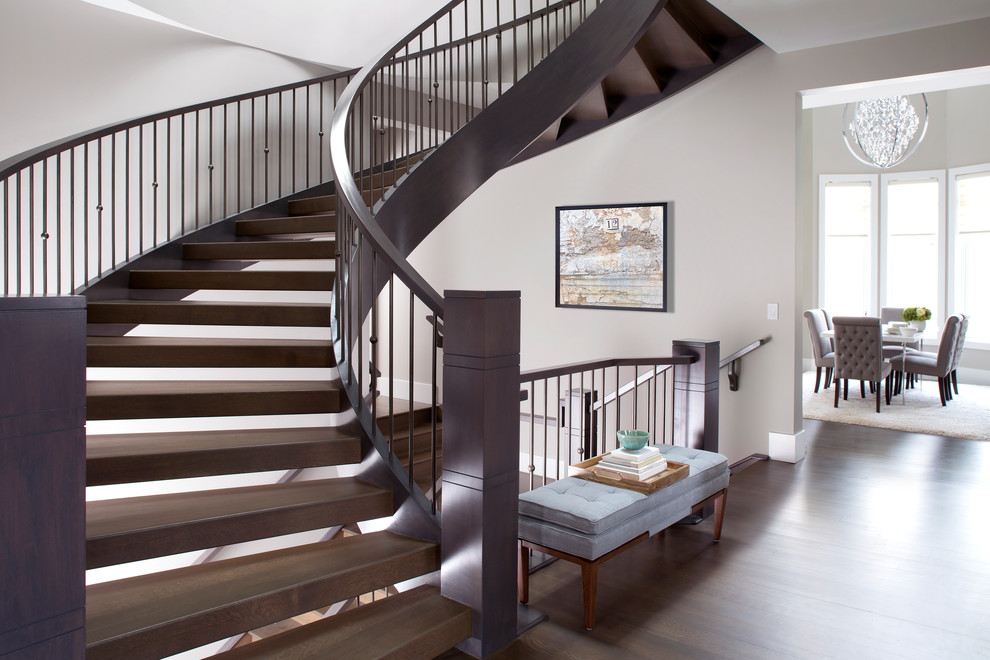 Staircase - large transitional wooden curved open staircase idea in Calgary