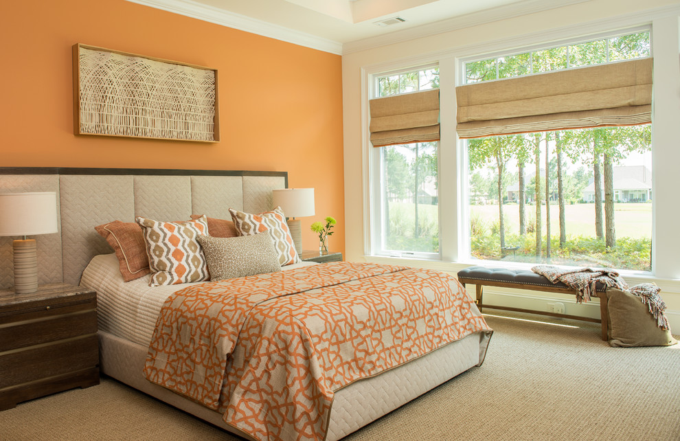 This is an example of a mid-sized traditional bedroom in Atlanta with orange walls, carpet and no fireplace.