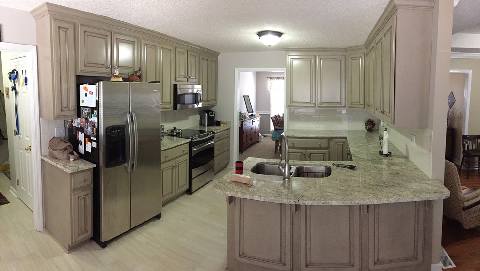 Example of a transitional eat-in kitchen design with a double-bowl sink, granite countertops, beige backsplash and no island