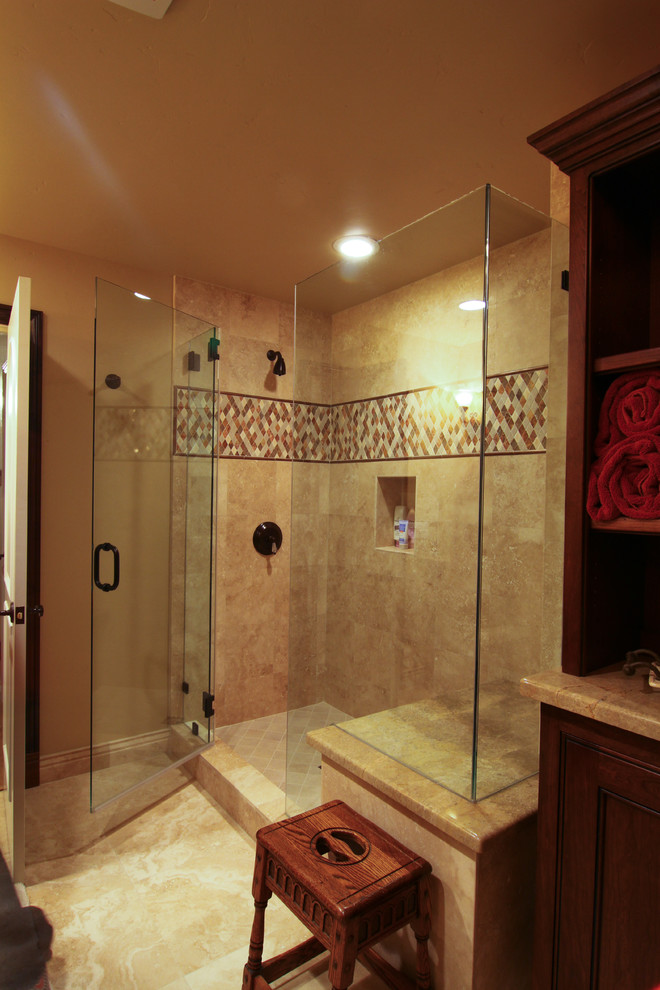 Photo of a mid-sized traditional 3/4 bathroom in Los Angeles with an alcove shower, a one-piece toilet, beige tile, brown tile, stone tile, beige walls and limestone floors.
