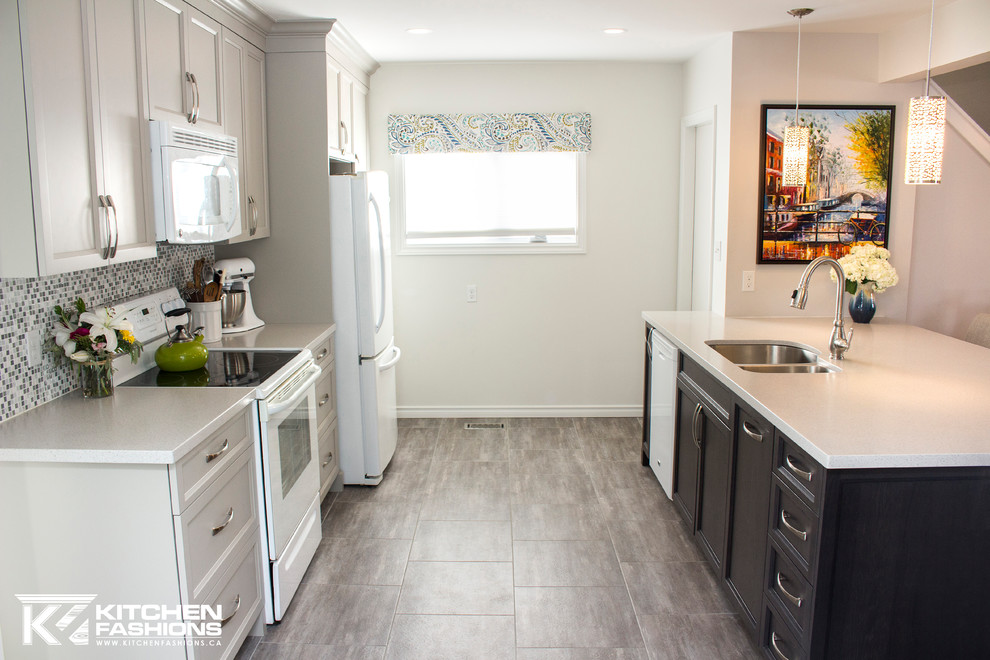 Inspiration for a mid-sized transitional single-wall ceramic tile open concept kitchen remodel with an undermount sink, shaker cabinets, gray cabinets, solid surface countertops, gray backsplash, mosaic tile backsplash, white appliances and an island