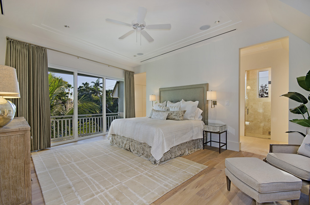 Design ideas for a contemporary bedroom in Miami with white walls and light hardwood floors.