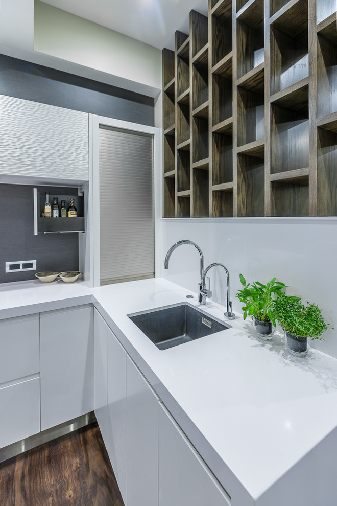 Inspiration for a large modern u-shaped open plan kitchen in Auckland with a triple-bowl sink, flat-panel cabinets, white cabinets, stainless steel benchtops, black splashback, porcelain splashback, black appliances, dark hardwood floors and with island.