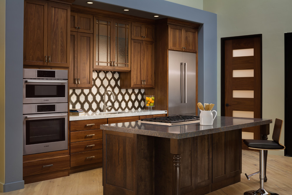 Inspiration for a mid-sized transitional galley light wood floor and beige floor eat-in kitchen remodel in San Francisco with a double-bowl sink, dark wood cabinets, quartzite countertops, white backsplash, ceramic backsplash, stainless steel appliances and an island