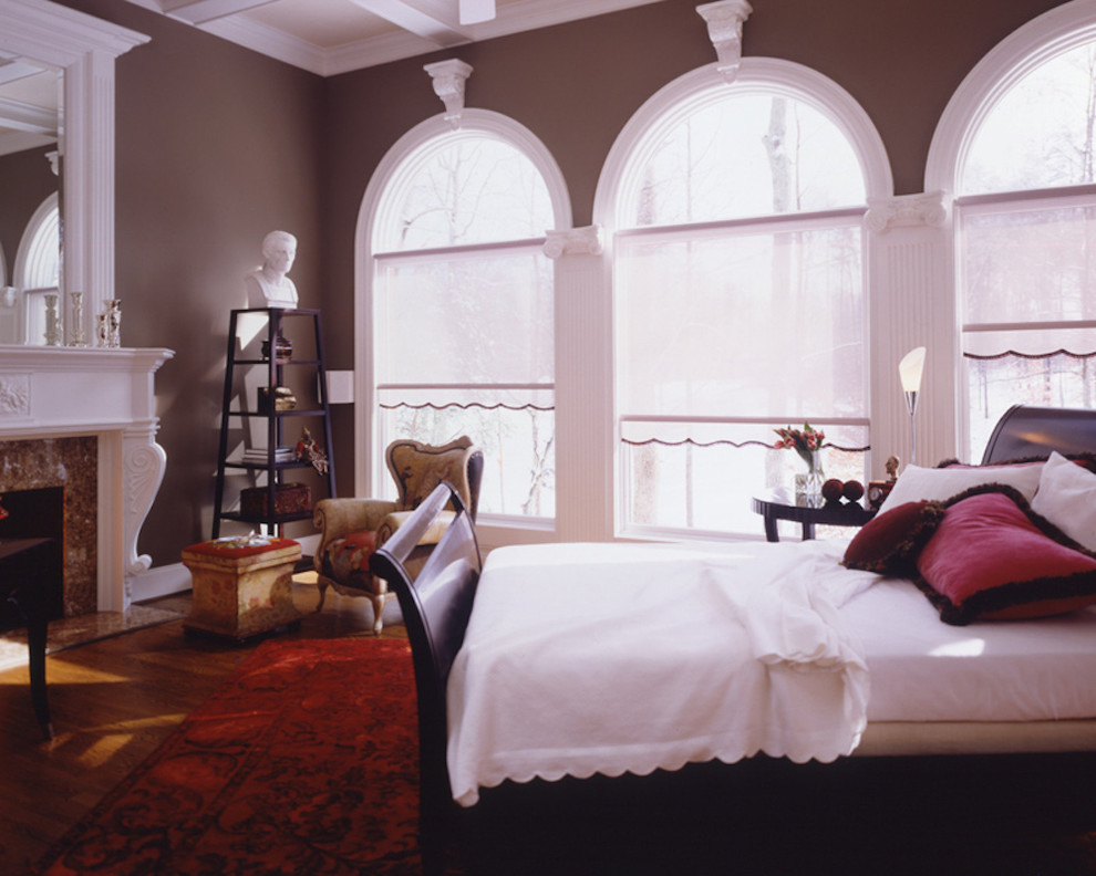 Mid-sized transitional master light wood floor bedroom photo in Indianapolis with brown walls, a standard fireplace and a stone fireplace