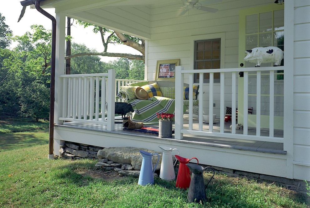 This is an example of a country verandah in New York with decking and a roof extension.