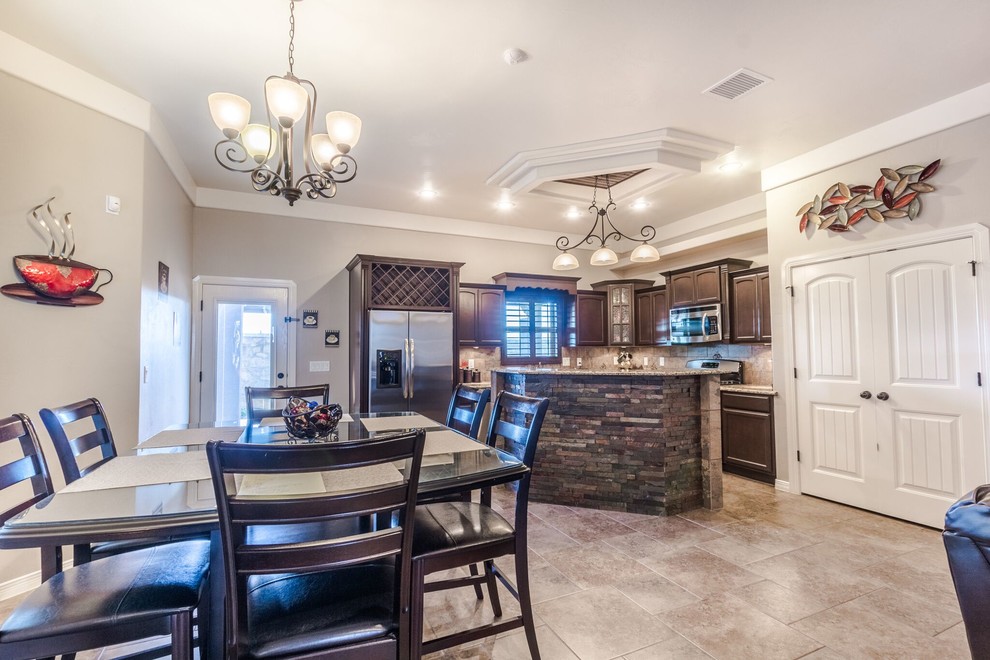 Example of a mid-sized transitional u-shaped ceramic tile home design design in Austin with a double-bowl sink, flat-panel cabinets, dark wood cabinets, granite countertops, beige backsplash, ceramic backsplash, stainless steel appliances and an island