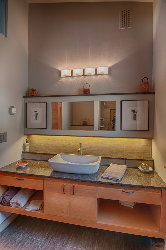 Inspiration for a mid-sized contemporary 3/4 bathroom in Seattle with open cabinets, medium wood cabinets, beige tile, porcelain tile, grey walls, porcelain floors, a vessel sink and engineered quartz benchtops.