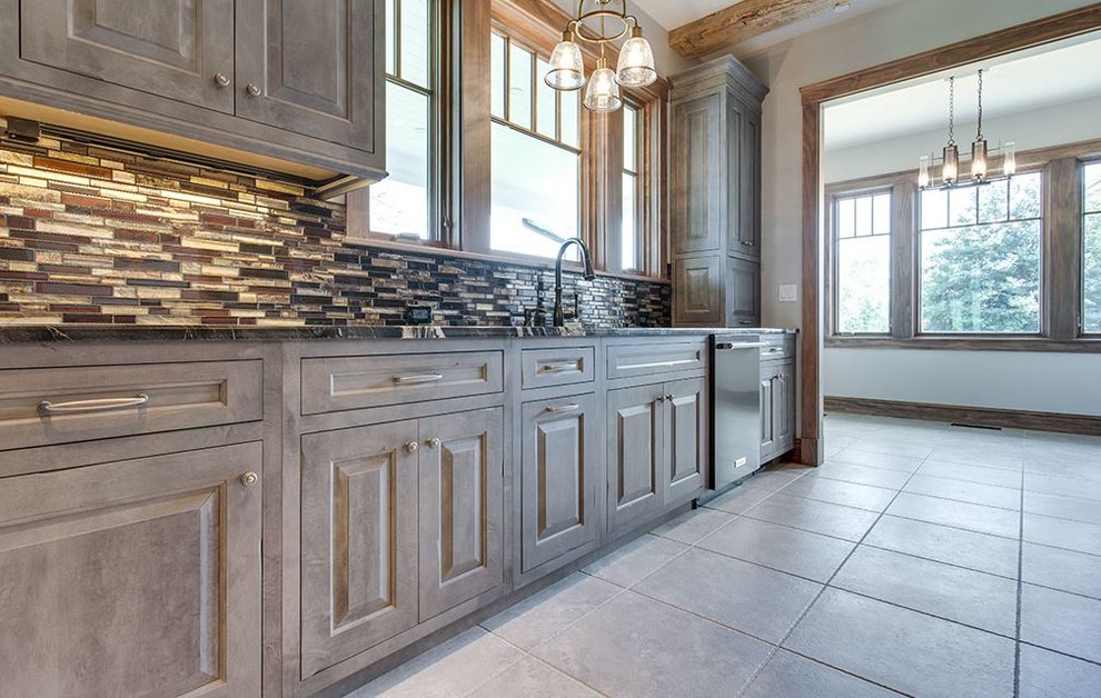 Inspiration for a large country single-wall eat-in kitchen in Philadelphia with a single-bowl sink, beaded inset cabinets, distressed cabinets, granite benchtops, grey splashback, mosaic tile splashback, stainless steel appliances, ceramic floors, grey floor and yellow benchtop.
