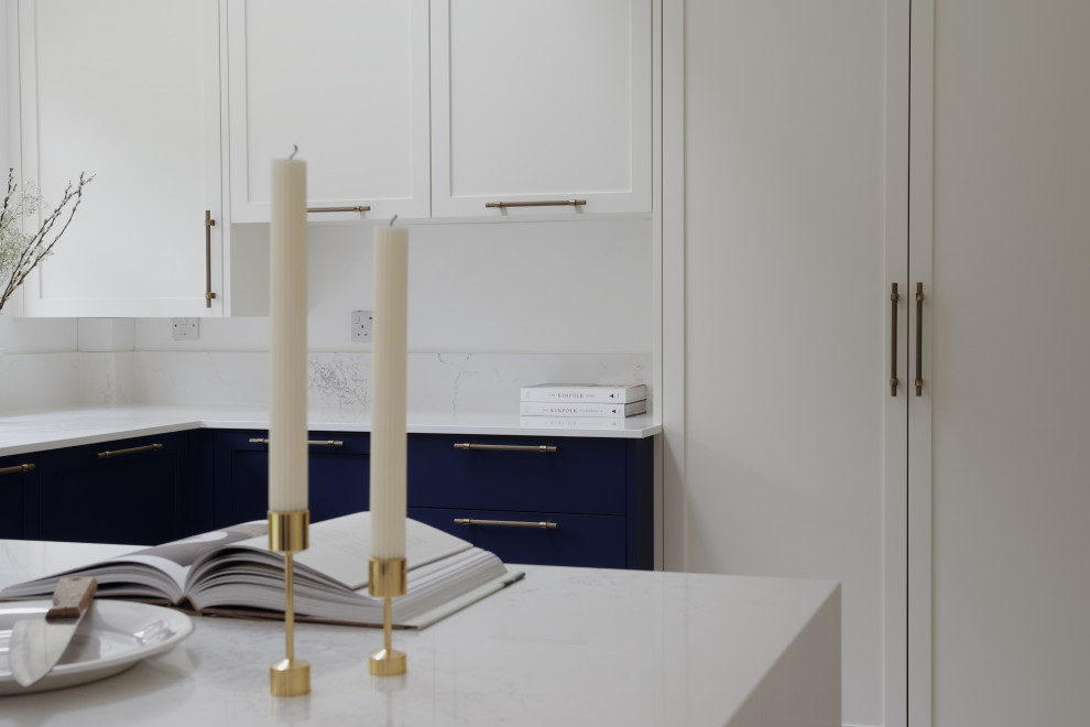 Photo of a medium sized traditional u-shaped enclosed kitchen in London with shaker cabinets, blue cabinets, quartz worktops, no island and white worktops.