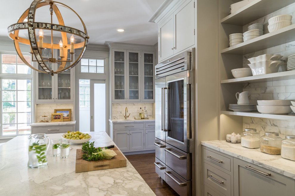Inspiration for a large beach style eat-in kitchen in San Francisco with a farmhouse sink, open cabinets, white splashback, stainless steel appliances, with island and dark hardwood floors.