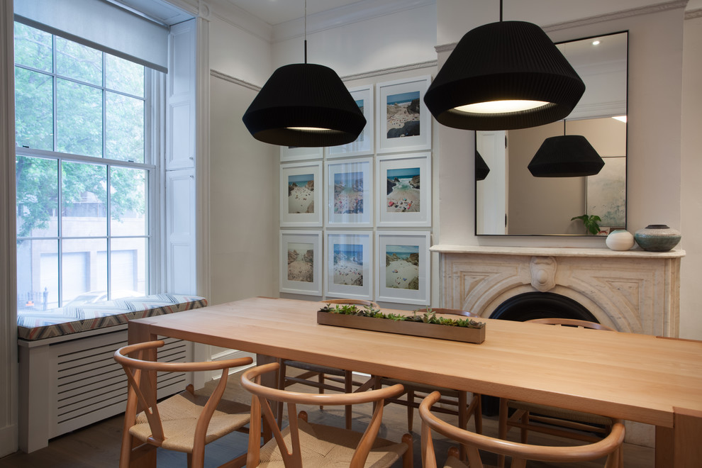 Transitional dark wood floor and brown floor dining room photo in Chicago with beige walls and a standard fireplace