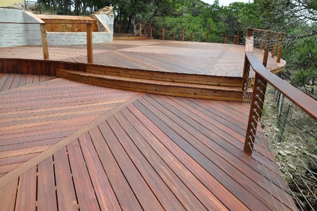 Example of a large transitional backyard water fountain deck design in Austin with no cover