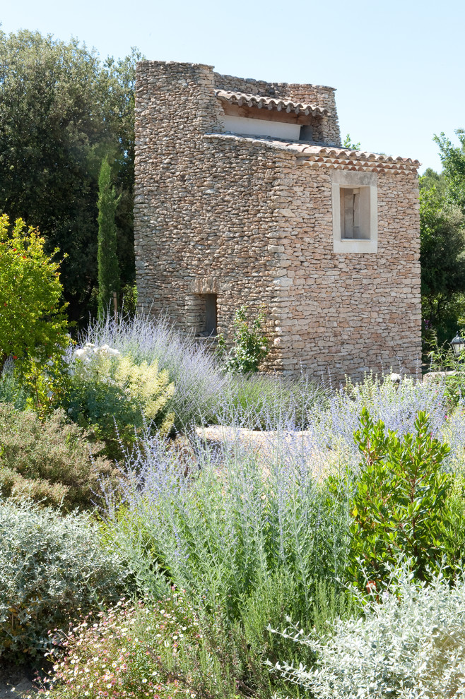 This is an example of a medium sized mediterranean detached guesthouse in Other.