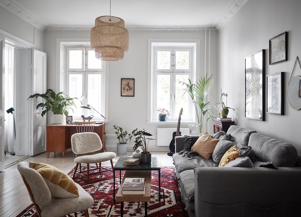 Immagine di un soggiorno scandinavo di medie dimensioni e chiuso con pareti bianche, pavimento in legno verniciato e pavimento bianco