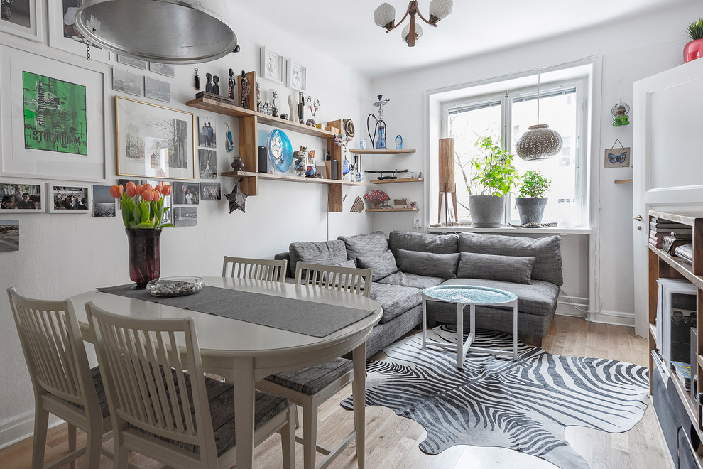 Inspiration for a small eclectic light wood floor and beige floor family room remodel in Stockholm with white walls