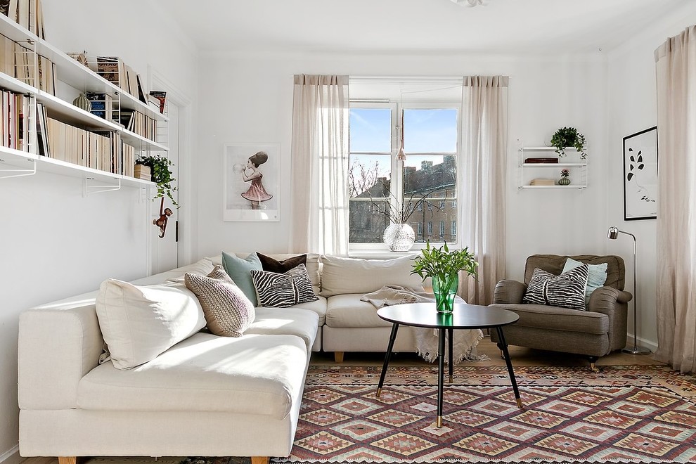 Family room library - mid-sized scandinavian family room library idea in Stockholm with white walls and no fireplace