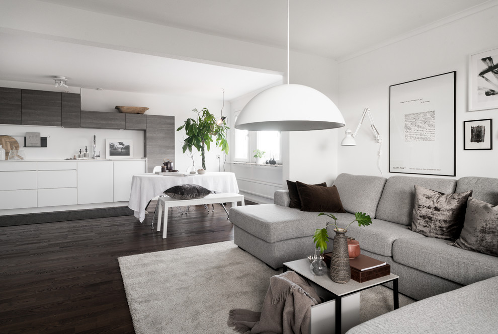 Design ideas for a medium sized scandi open plan games room in Stockholm with white walls, dark hardwood flooring and black floors.