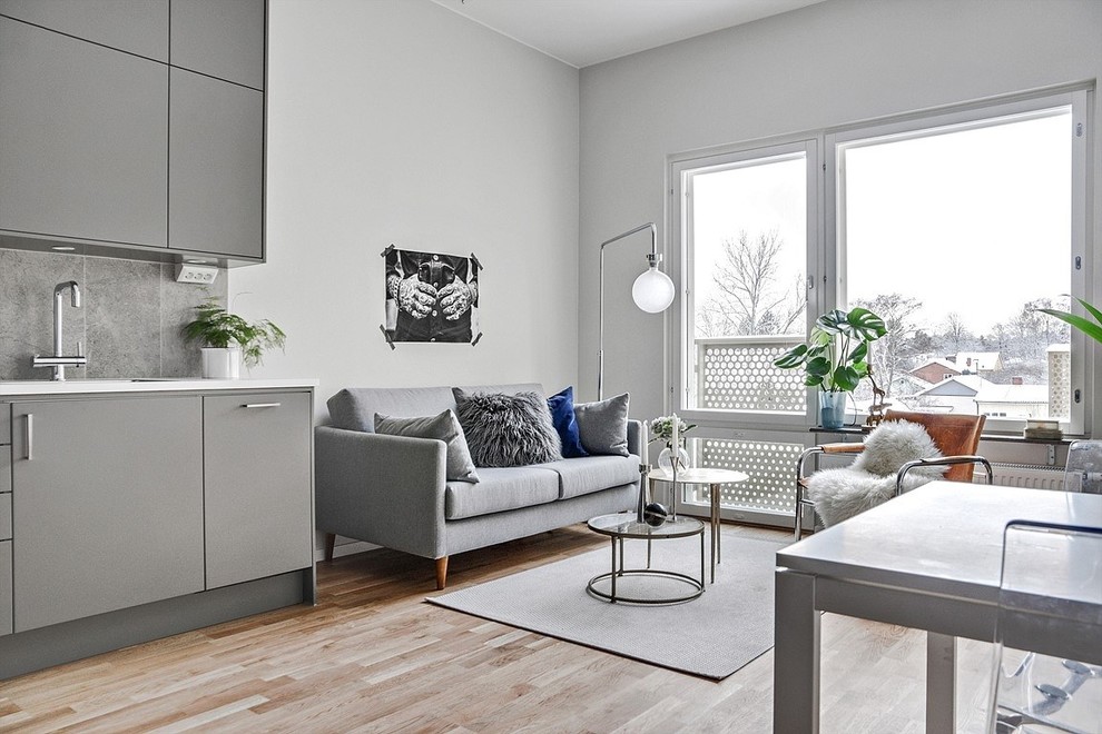 Example of a danish family room design in Stockholm with gray walls