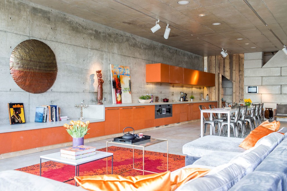 Large eclectic open concept concrete floor and gray floor family room photo in Barcelona with gray walls