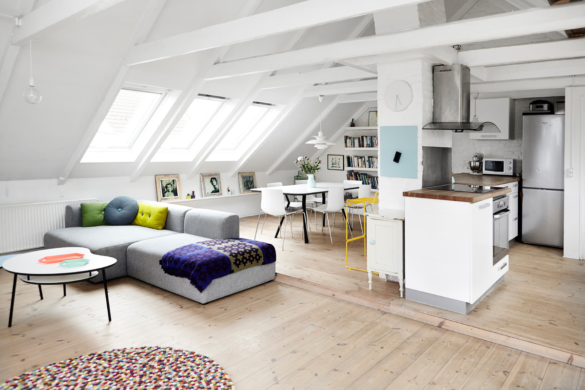 Example of a large danish light wood floor family room design in Aarhus with white walls
