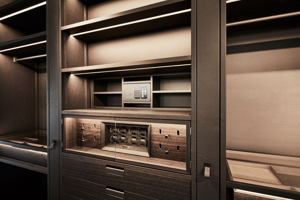 Inspiration for a large contemporary dressing room remodel in Munich with glass-front cabinets