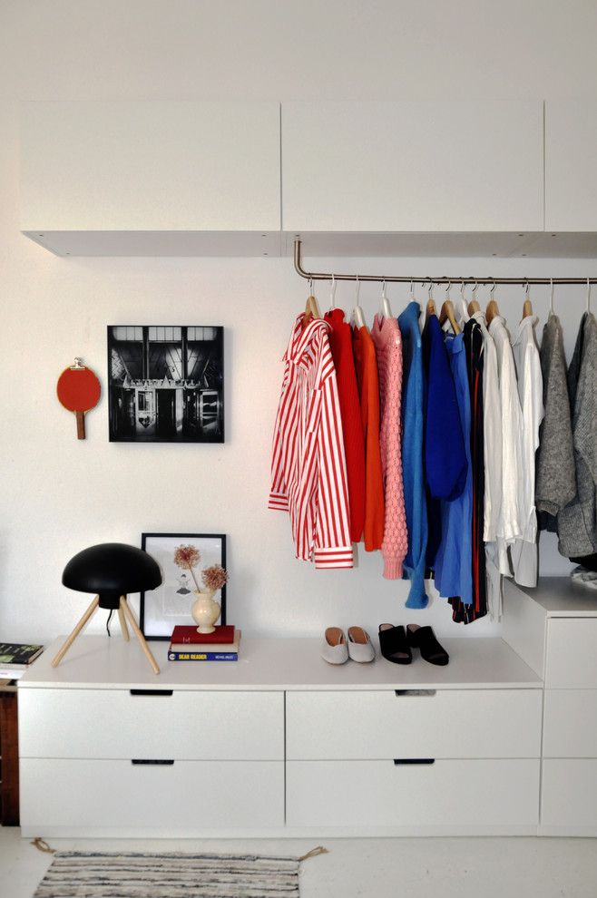 This is an example of a scandinavian wardrobe for women in Berlin with flat-panel cabinets and white cabinets.