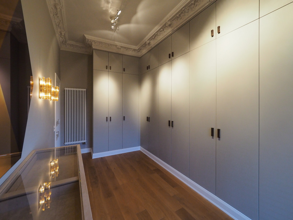 Reach-in closet - huge contemporary reach-in closet idea in Hamburg with flat-panel cabinets