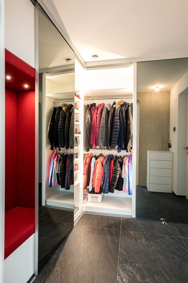 Dressing room - mid-sized contemporary gender-neutral slate floor and black floor dressing room idea in Stuttgart with flat-panel cabinets