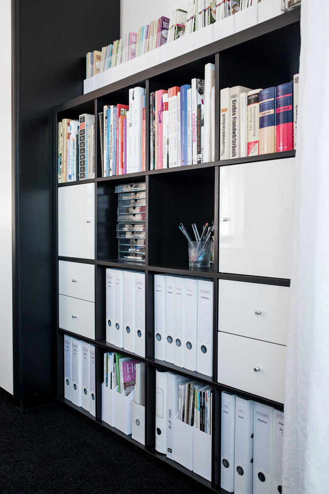 Home office - eclectic freestanding desk carpeted and black floor home office idea in Berlin with white walls