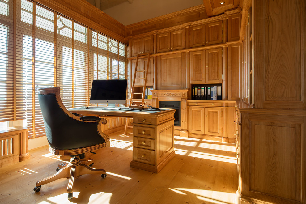 Photo of a medium sized classic home office in Other with light hardwood flooring and a metal fireplace surround.