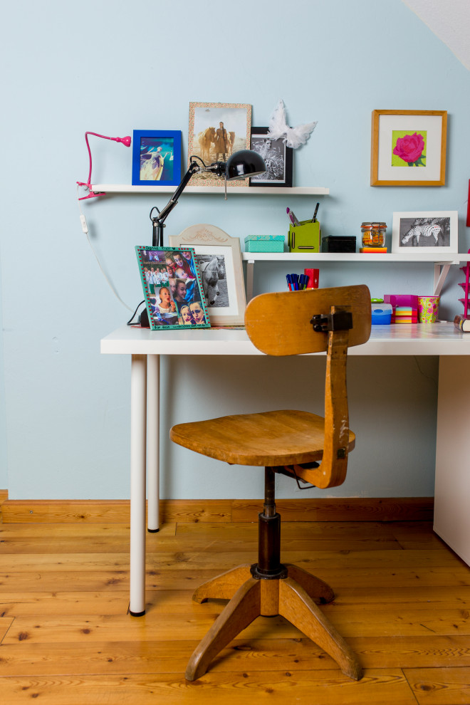 Esempio di un ufficio design di medie dimensioni con pareti blu, parquet chiaro, scrivania autoportante e pavimento marrone