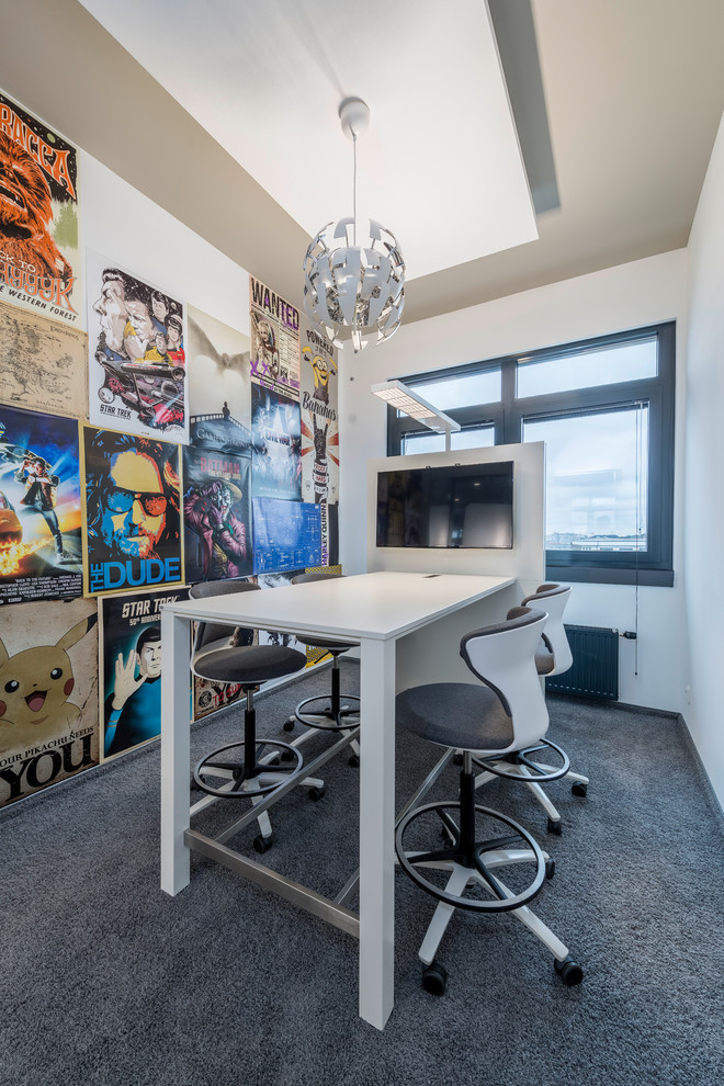 Example of a minimalist carpeted and gray floor home office design in Hamburg with white walls