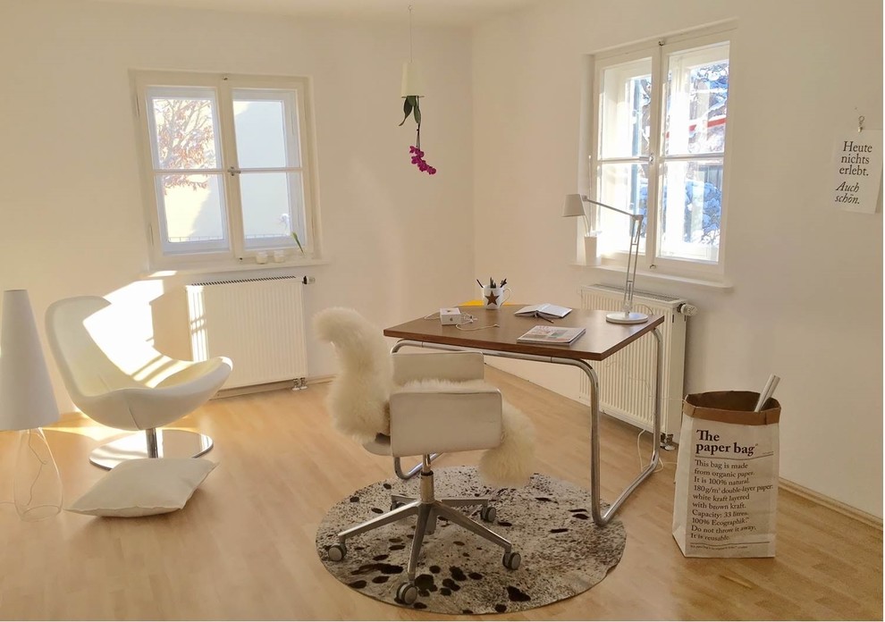 Skandinavisches Arbeitszimmer mit Arbeitsplatz, hellem Holzboden und freistehendem Schreibtisch in München