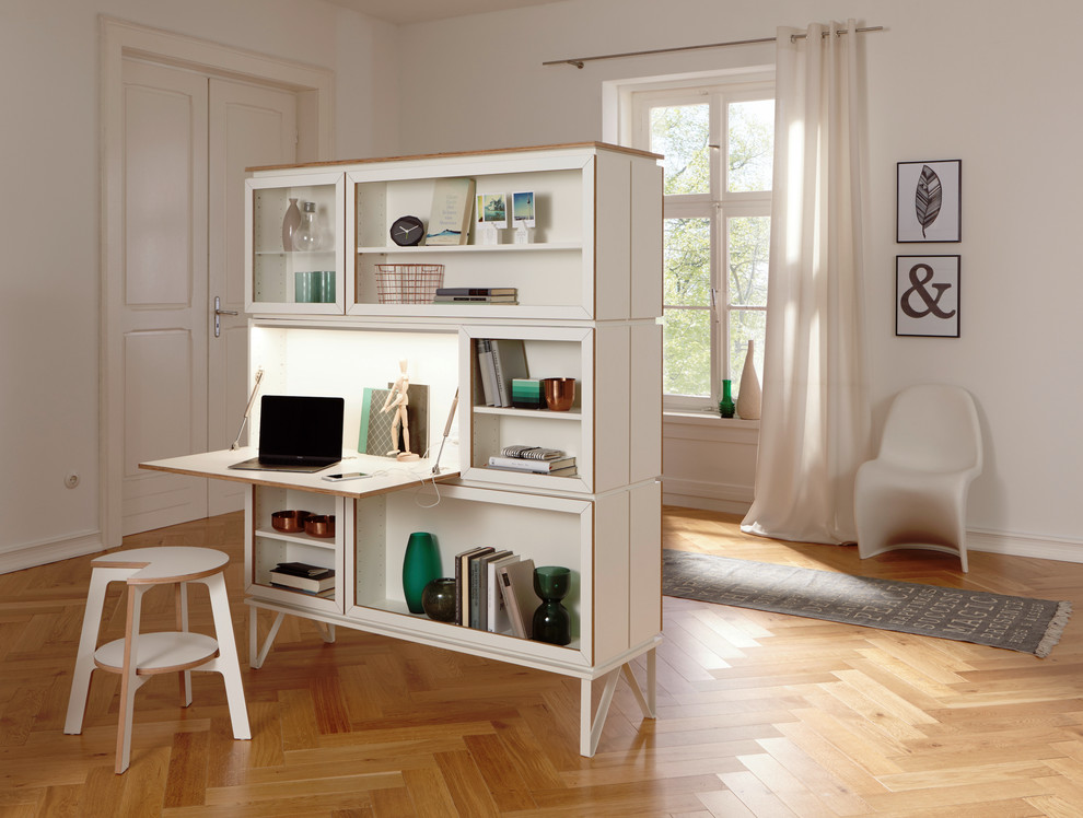 Mid-sized trendy freestanding desk medium tone wood floor and brown floor study room photo in Berlin with white walls