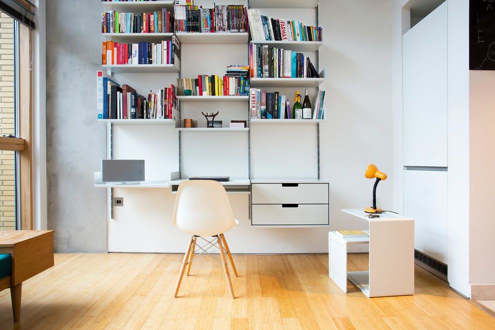 Foto de despacho contemporáneo de tamaño medio sin chimenea con paredes blancas, suelo de madera clara y escritorio empotrado