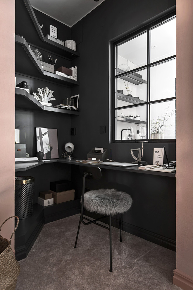 Photo of a scandinavian home studio in Stockholm with black walls, carpet, a built-in desk and grey floors.