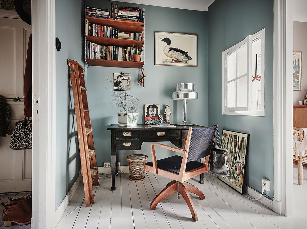 Inspiration for a mid-sized scandinavian freestanding desk painted wood floor study room remodel in Gothenburg with blue walls and no fireplace