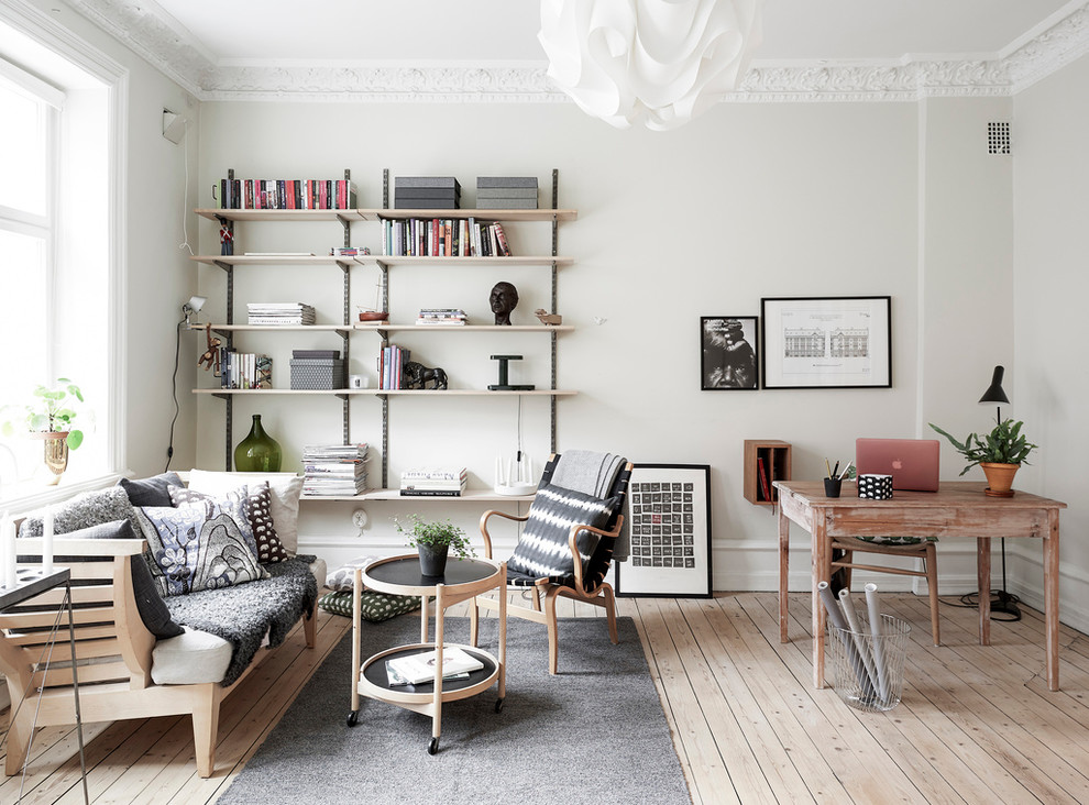 Study room - mid-sized scandinavian freestanding desk light wood floor study room idea in Gothenburg with white walls and no fireplace